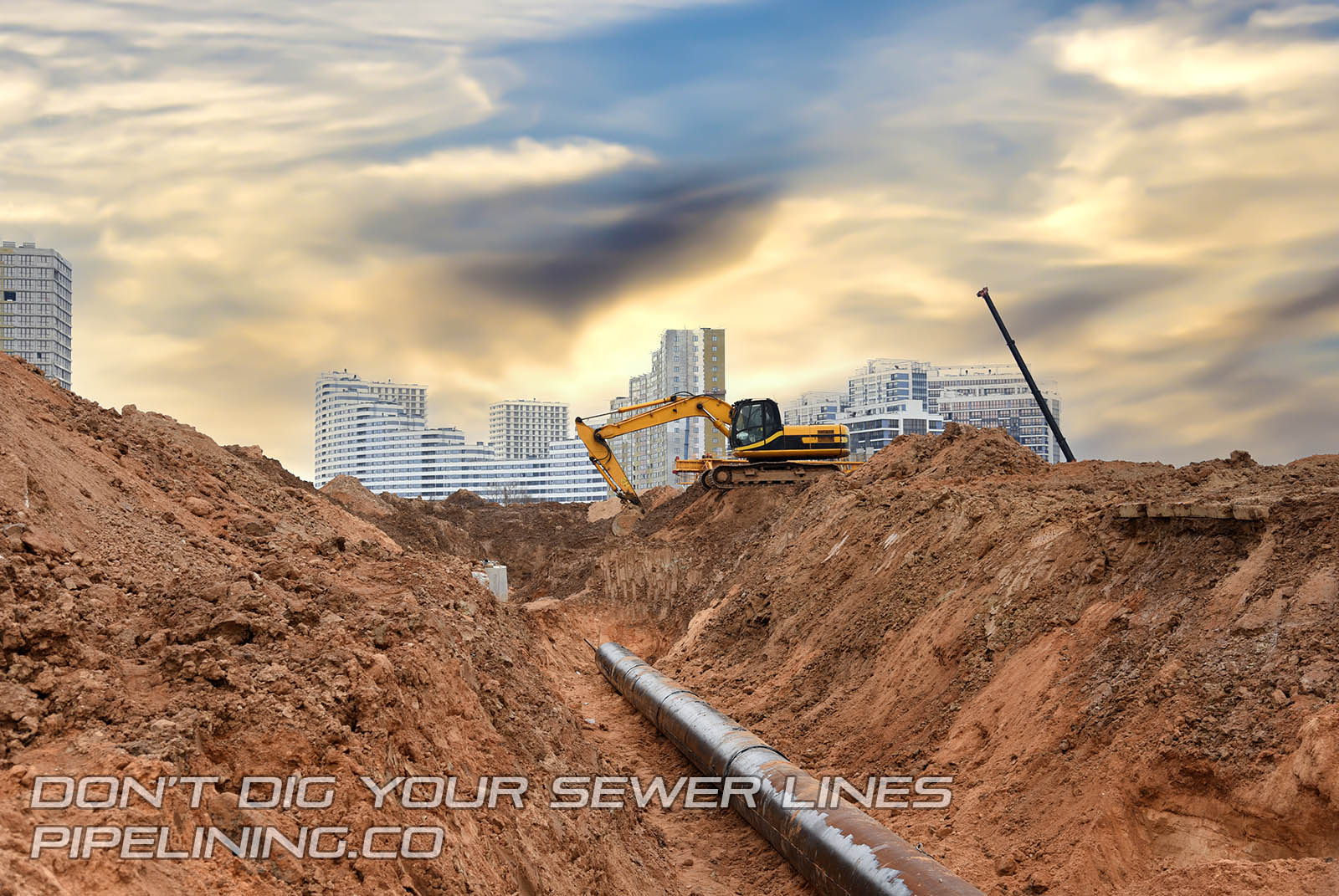 Excavator at construction site digging up sewer lines